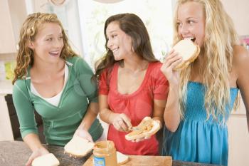 Royalty Free Photo of Girls Eating Sandwiches