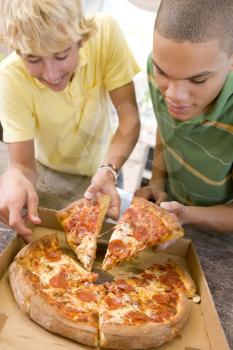 Royalty Free Photo of Boys Eating Pizza