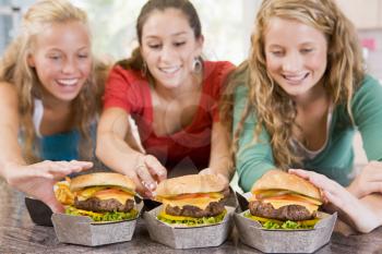 Royalty Free Photo of Girls Eating Burgers