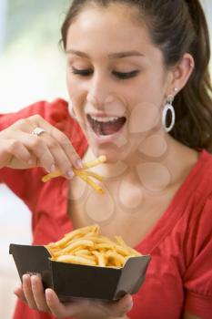 Royalty Free Photo of a Girl Eating French Fries