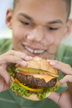 Royalty Free Photo of a Boy Eating a Burger