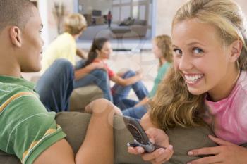 Royalty Free Photo of Teens Watching TV and Using Cellphones