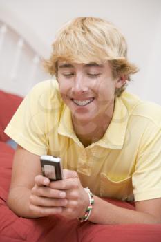 Royalty Free Photo of a Boy Using a Mobile Phone