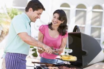 Royalty Free Photo of a Couple Barbecuing