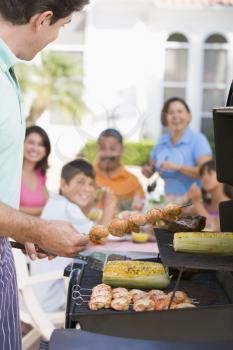 Royalty Free Photo of a Family Enjoying a Barbecue