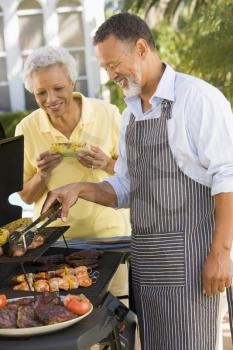 Royalty Free Photo of a Couple Barbecuing