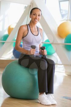 Royalty Free Photo of a Woman With Weights and a Swiss Ball