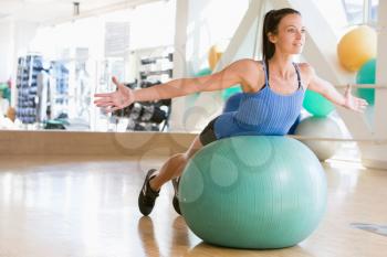 Royalty Free Photo of a Girl Using a Medicine Ball