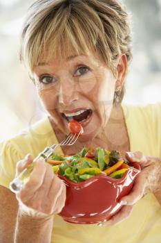 Royalty Free Photo of a Woman Eating a Salad