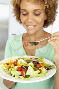 Royalty Free Photo of a Woman Eating Salad