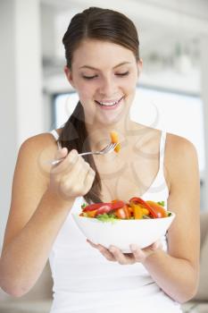 Royalty Free Photo of a Girl Eating a Salad