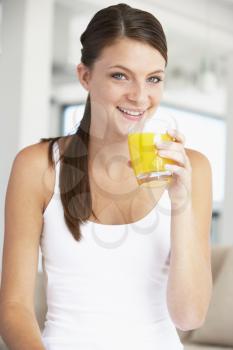 Royalty Free Photo of a Girl Drinking Orange Juice