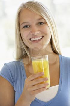 Royalty Free Photo of a Girl With a Glass of Orange Juice