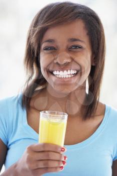 Royalty Free Photo of a Teen Drinking Orange Juice