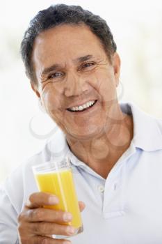 Royalty Free Photo of a Man Drinking Orange Juice