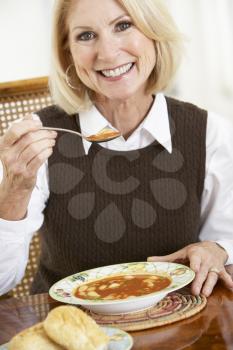 Royalty Free Photo of a Woman Eating Soup