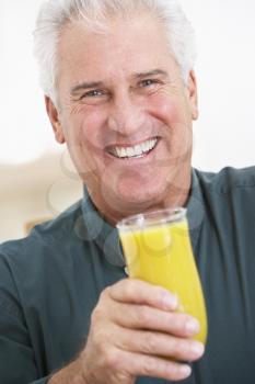 Royalty Free Photo of a Man Drinking Orange Juice