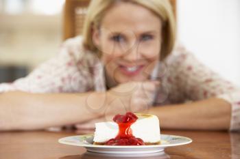 Royalty Free Photo of a Woman Looking at Cheesecake