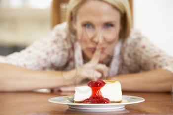 Royalty Free Photo of a Woman Looking at Cheesecake