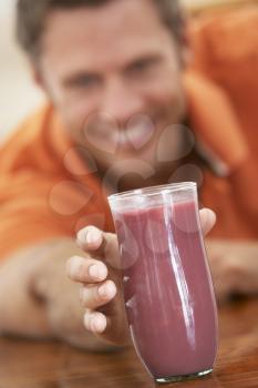 Royalty Free Photo of a Man Reaching for a Smoothie