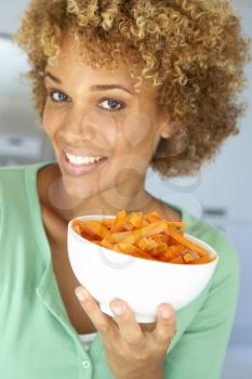 Royalty Free Photo of a Woman With a Bowl of Carrots