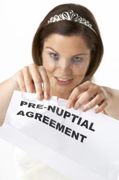 Royalty Free Photo of a Bride Tearing Up a Pre-Nuptial Agreement