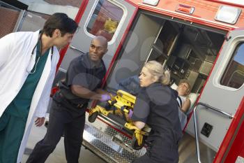 Royalty Free Photo of a Paramedic and Doctors Unloading  Patient