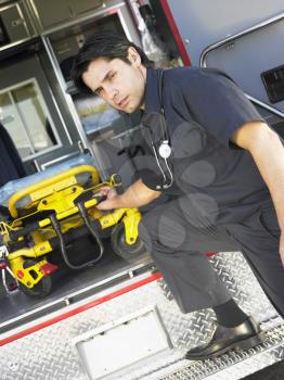 Royalty Free Photo of a Paramedic Removing a Gurney