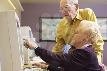 Royalty Free Photo of a Senior Man and Woman at a Computer