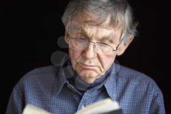 Royalty Free Photo of a Man Reading a Book
