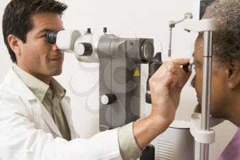 Royalty Free Photo of a Doctor Checking a Patient's Eyes