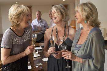 Royalty Free Photo of Women With Champagne at a Dinner Party