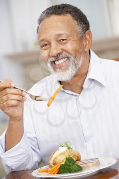 Royalty Free Photo of a Man Enjoying a Meal