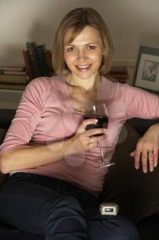 Royalty Free Photo of a Woman With Wine Watching TV