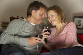 Royalty Free Photo of a Couple Drinking Wine and Laughing