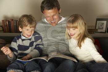 Royalty Free Photo of a Father Reading to His Children
