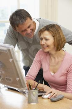 Royalty Free Photo of a Couple at the Computer