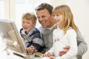 Royalty Free Photo of a Father With His Children at the Computer