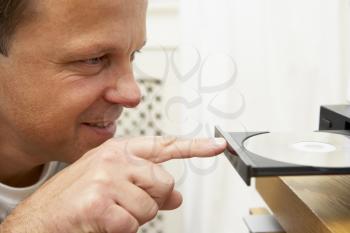 Royalty Free Photo of a Man Closing a CD Player