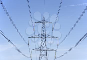 Royalty Free Photo of Hydro Towers Against a Blue Sky
