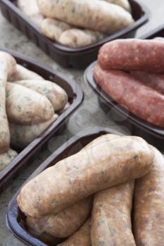 Royalty Free Photo of a Variety of Sausages in Pans