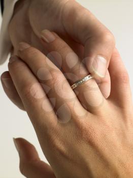 Royalty Free Photo of a Man Putting a Ring on a Woman's Hand