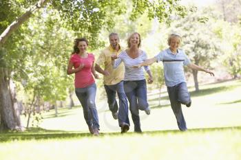 Royalty Free Photo of a Family Running in the Park