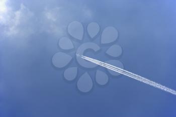 Royalty Free Photo of a Condensation Trail Behind an Airplane