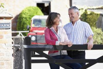 Royalty Free Photo of a Farm Couple at the Gate
