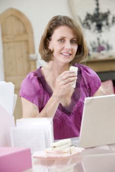 Royalty Free Photo of a Woman Eating Her Lunch at Her Desk