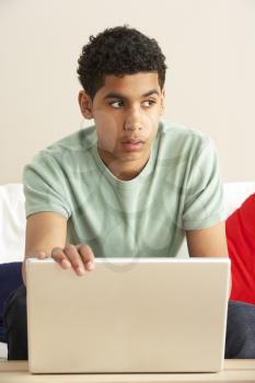 Royalty Free Photo of a Boy Looking Worried at a Laptop