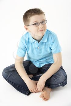 Royalty Free Photo of a Little Boy Sitting on the Floor
