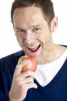 Royalty Free Photo of a Man Taking a Bite of an Apple
