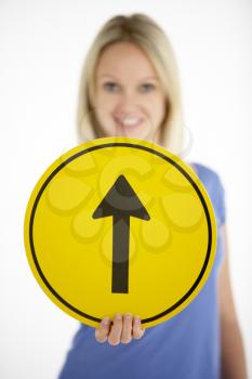 Royalty Free Photo of a Woman With an Arrow Sign